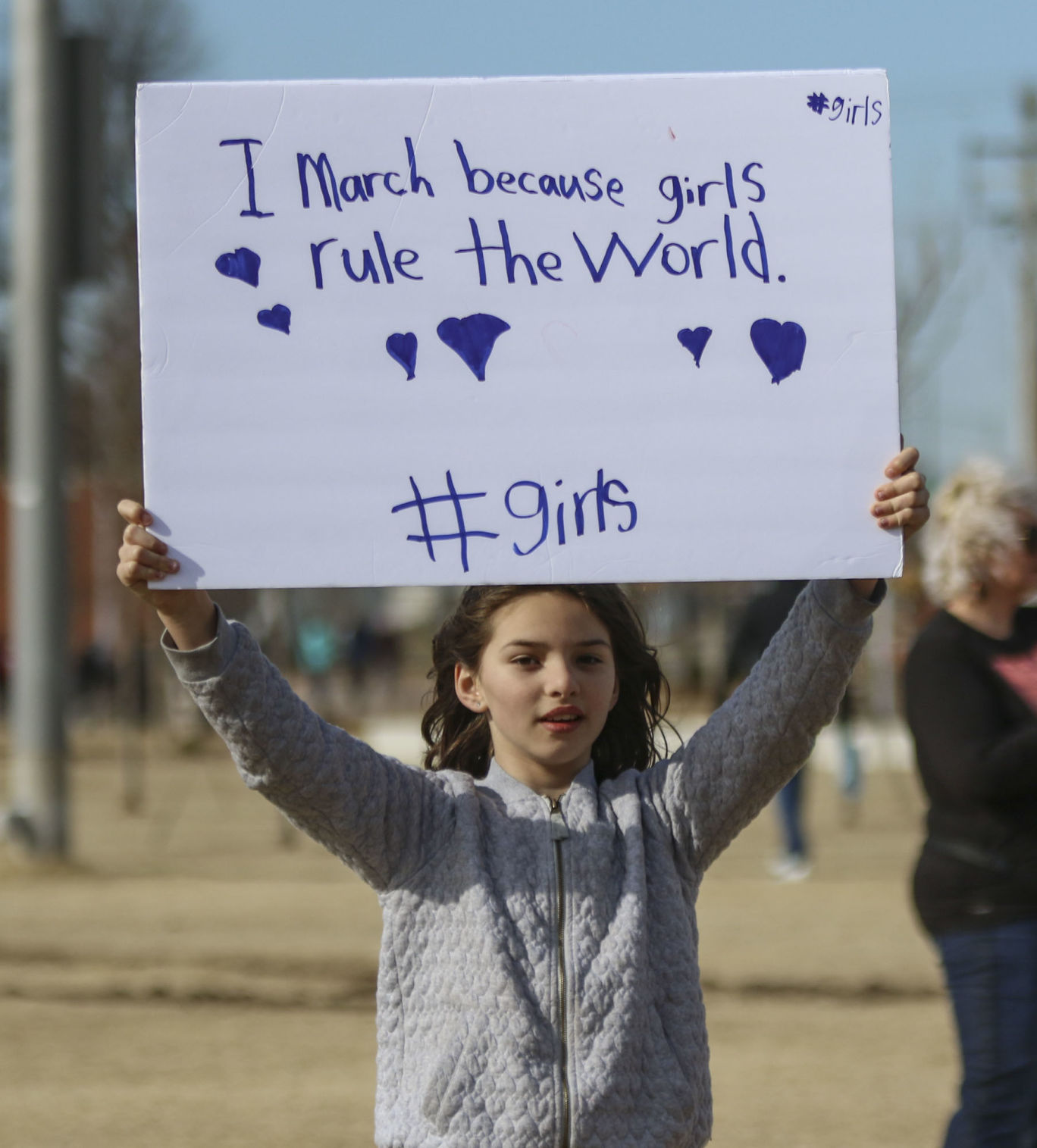 “I march because girls rule the world #girls” sign